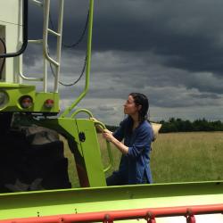 An image of Helen Anne Curry riding a tractor