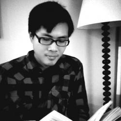 A black and white photo of Leo Chu reading a book