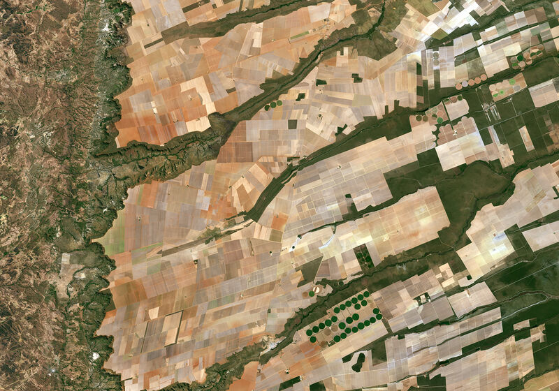 European Space Agency Sentinel 2A image of Brazilian farms from space. From ESA: "Here we can see a large, flat plateau blanked with fields benefiting from rich soils and an apparent abundance of water, before falling off into a green, hilly valley (left)